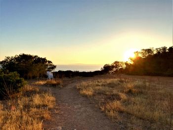 Scenic view of land against sky during sunset