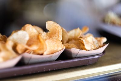 Close-up of potato chips in tray on table