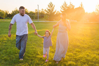 Full length of father and daughter on grass