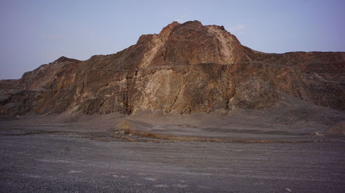 Rock formations on landscape against clear sky