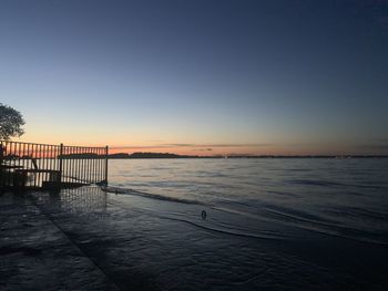 Scenic view of sea against clear sky during sunset