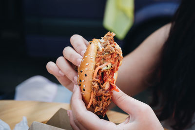 Close-up of woman holding burger