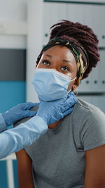 Portrait of young woman wearing protective mask