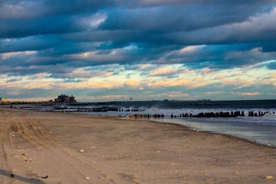 Scenic view of beach against sky during sunset