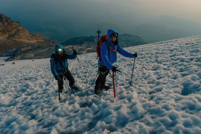 Rear view of man skiing on snow covered mountain