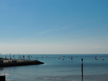 Scenic view of sea against clear blue sky