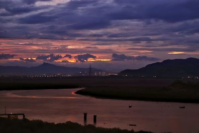 Scenic view of river against sky during sunset