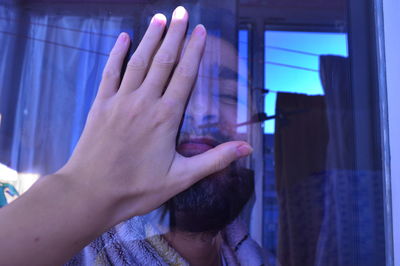Girl's hand covers the face of a man.fingers.closed face of a man.love.