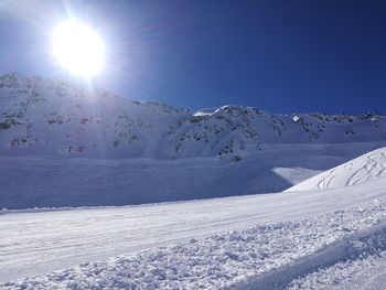 Scenic view of snow covered mountains against sky