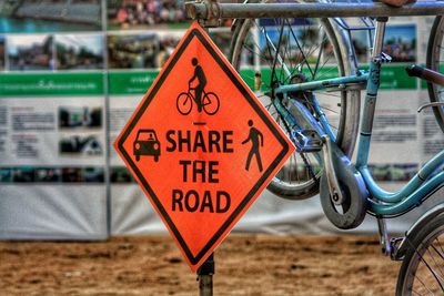 Close-up of road sign by bicycle