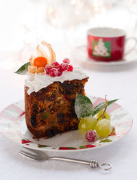 Traditional christmas fruit cake with white frosting and sugared fruits