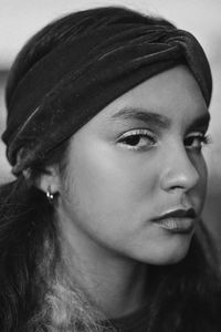 Close-up portrait of young woman looking away