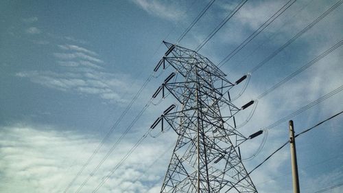 Low angle view of electricity pylon against sky