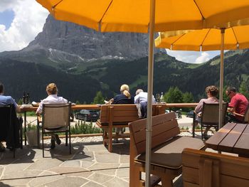 Rear view of people sitting on chair at restaurant