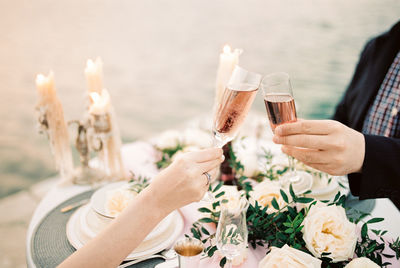 Midsection of woman drinking glass