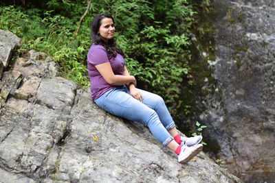 Woman sitting on rock