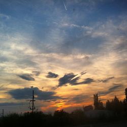 Low angle view of power lines against sky