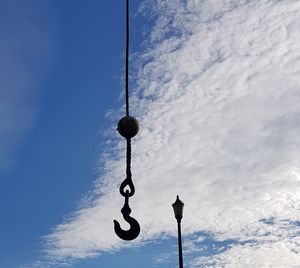 Low angle view of hanging light against sky