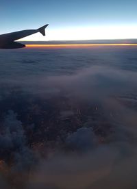 Airplane flying over sea against sky