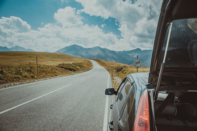 Car on roadside against sky