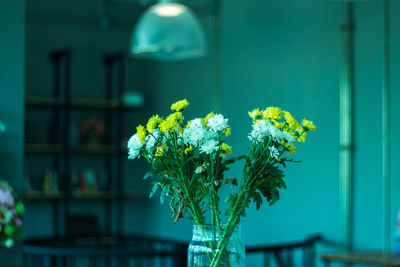 Close-up of yellow flowering plant in vase