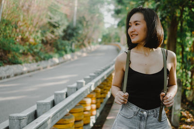 Full length of woman standing on road