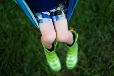 Low section of child playing on swing