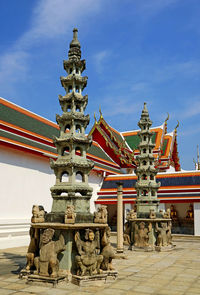 Chinese pagoda with mythological figures in wat pho buddhist temple, old city of bangkok, thailand