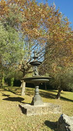 Fountain in park against sky during autumn