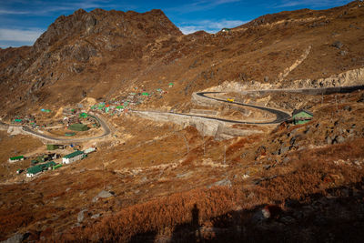 Himalayan breathtaking landscape with bright blue sky and twisty adventurous valley road