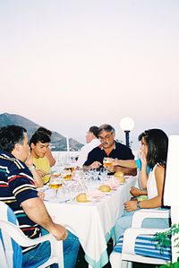 Group of people sitting on table at beach