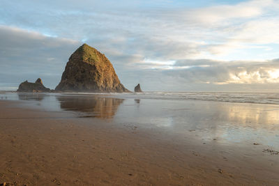 View of rocks on beach against sky