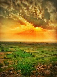 Scenic view of land against sky during sunset