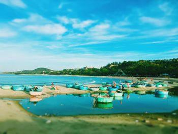Boats moored in lake against sky