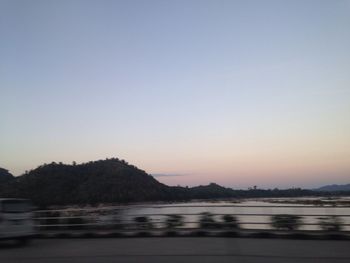 Scenic view of sea against clear sky during sunset