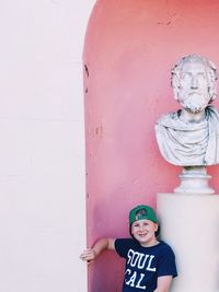 Close-up of boy statue against wall