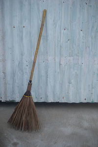 Broom against corrugated iron