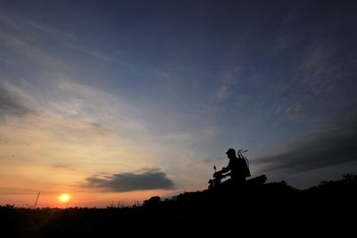 Low angle view of silhouette statue against sky during sunset