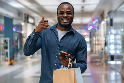 Portrait of young man using mobile phone