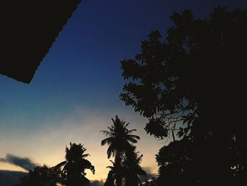 Low angle view of silhouette trees against sky at sunset