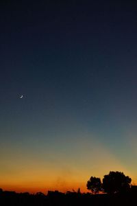 Silhouette of moon at sunset