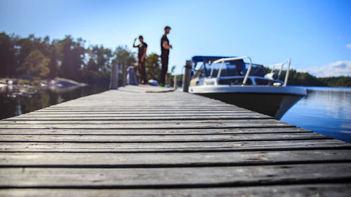 Pier over lake against clear sky