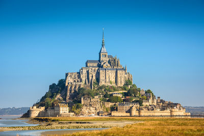 View of temple against clear blue sky