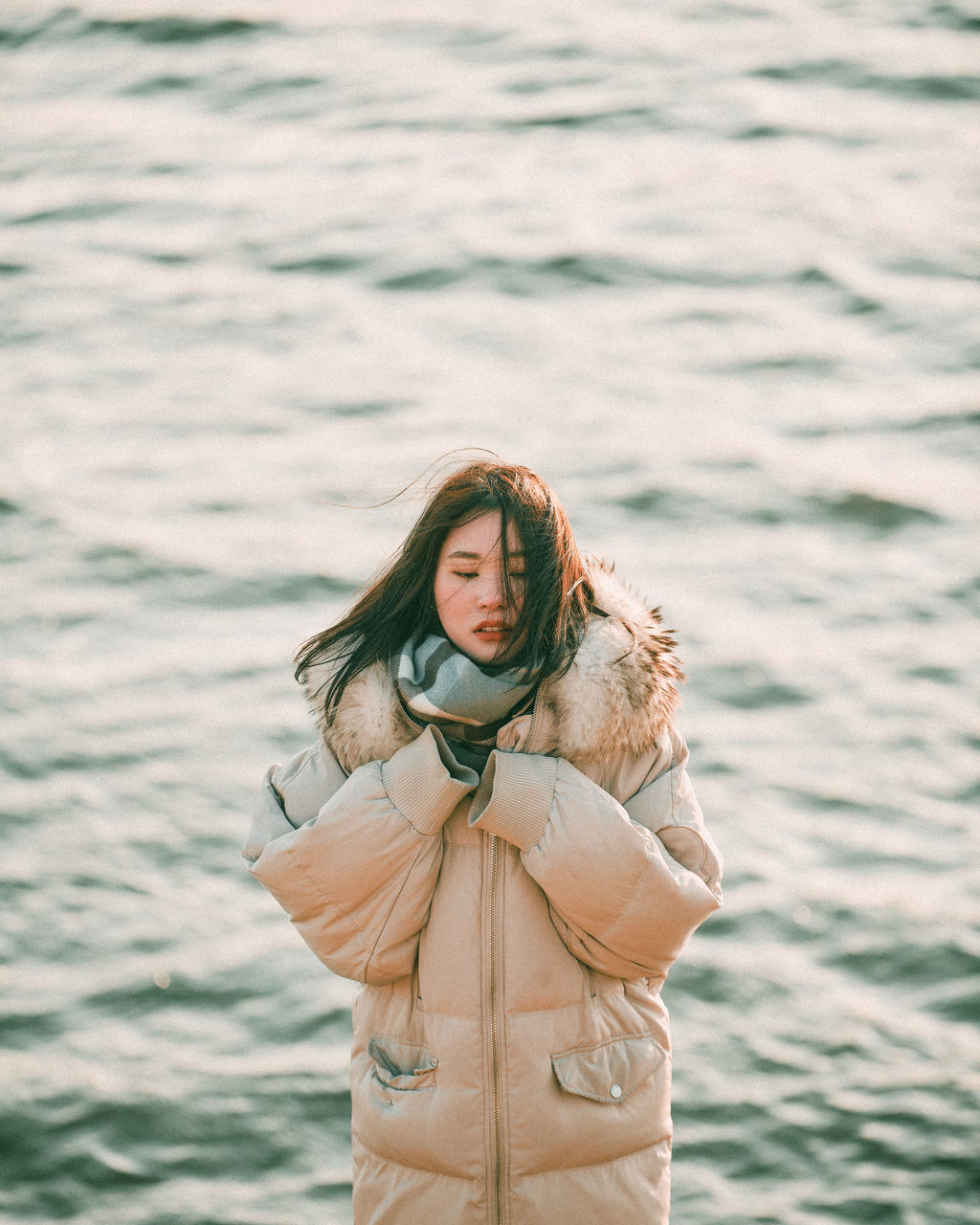water, one person, women, sea, long hair, adult, nature, young adult, standing, clothing, portrait, hairstyle, leisure activity, smiling, lifestyles, happiness, photo shoot, outdoors, female, holiday, emotion, front view, beauty in nature, vacation, trip, land, looking, three quarter length, day, casual clothing, travel, environment, person, looking at camera, brown hair, fashion, copy space