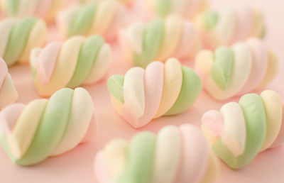 Colorful marshmallows composition on a pink background - copy space - children candies concept