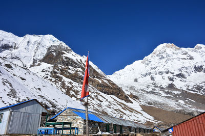 Scenic view of snowcapped mountains against clear blue sky