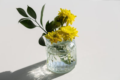 Close-up of yellow flower in vase on table