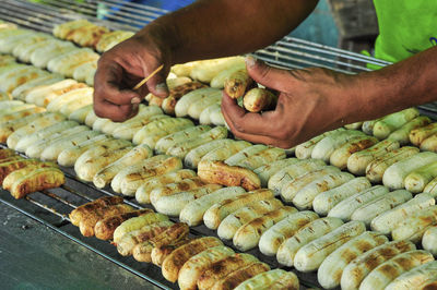 Midsection of man preparing food at market stall