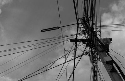 Low angle view of electricity pylon against sky