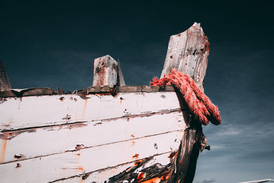 Low angle view of old rusty metallic structure against sky